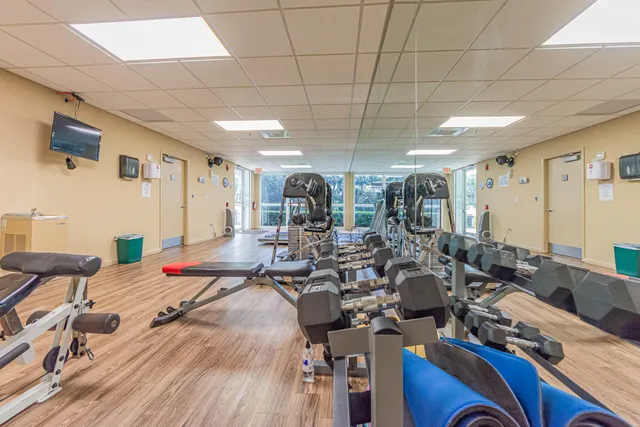 a lot of gym equipment sitting on a floor