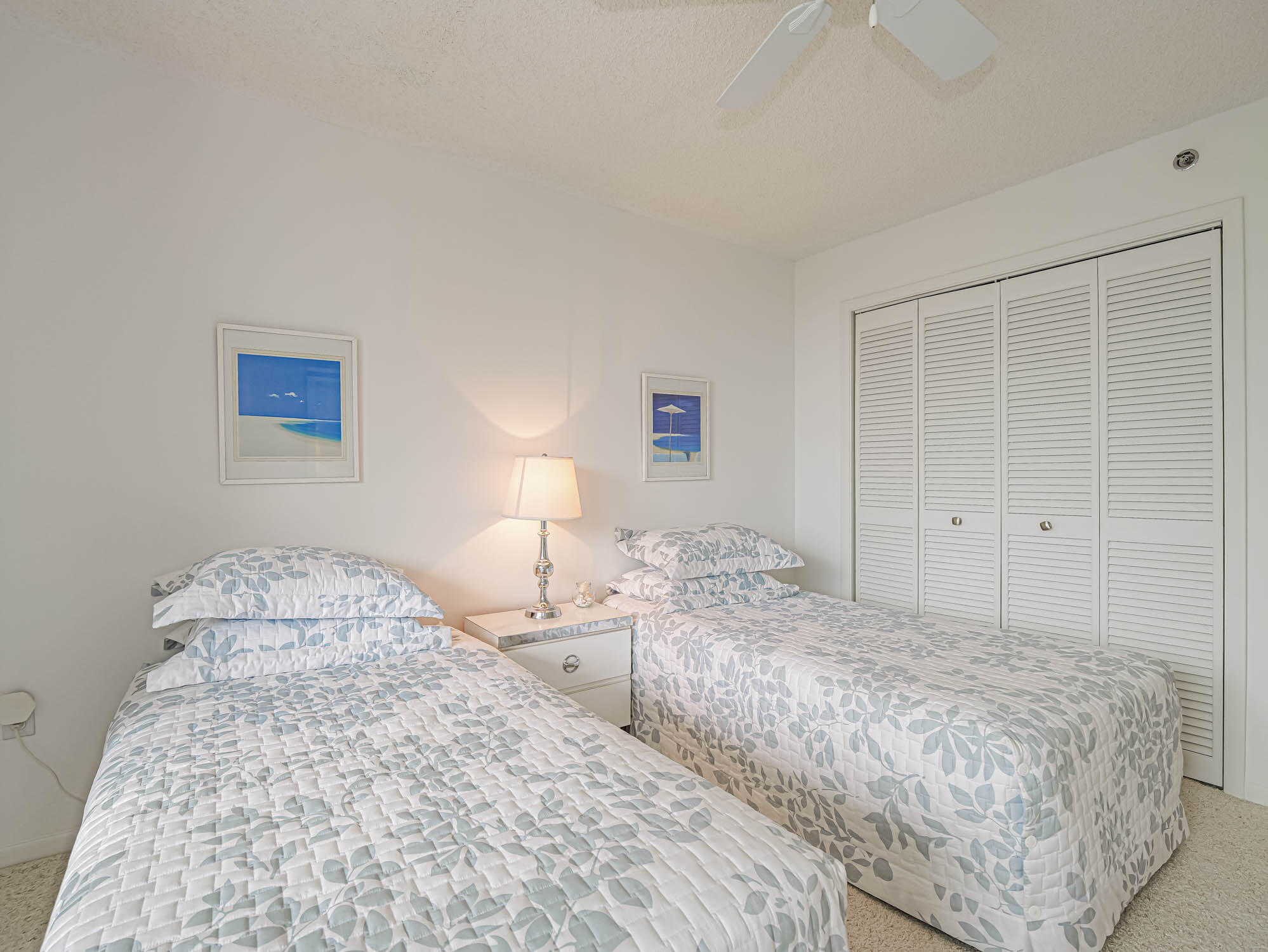 2700 North Hwy A1A, Unit 307 Hutchinson Island, FL 34949 - Photo 43 of 51 a bedroom with two beds and a lamp