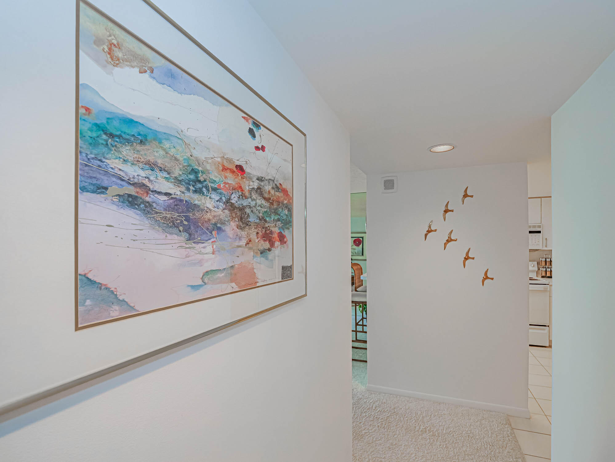 2700 North Hwy A1A, Unit 307 Hutchinson Island, FL 34949 - Photo 45 of 51 a view of a hallway with paintings on the wall