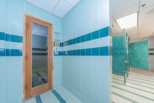 a bathroom with a shower and a sink