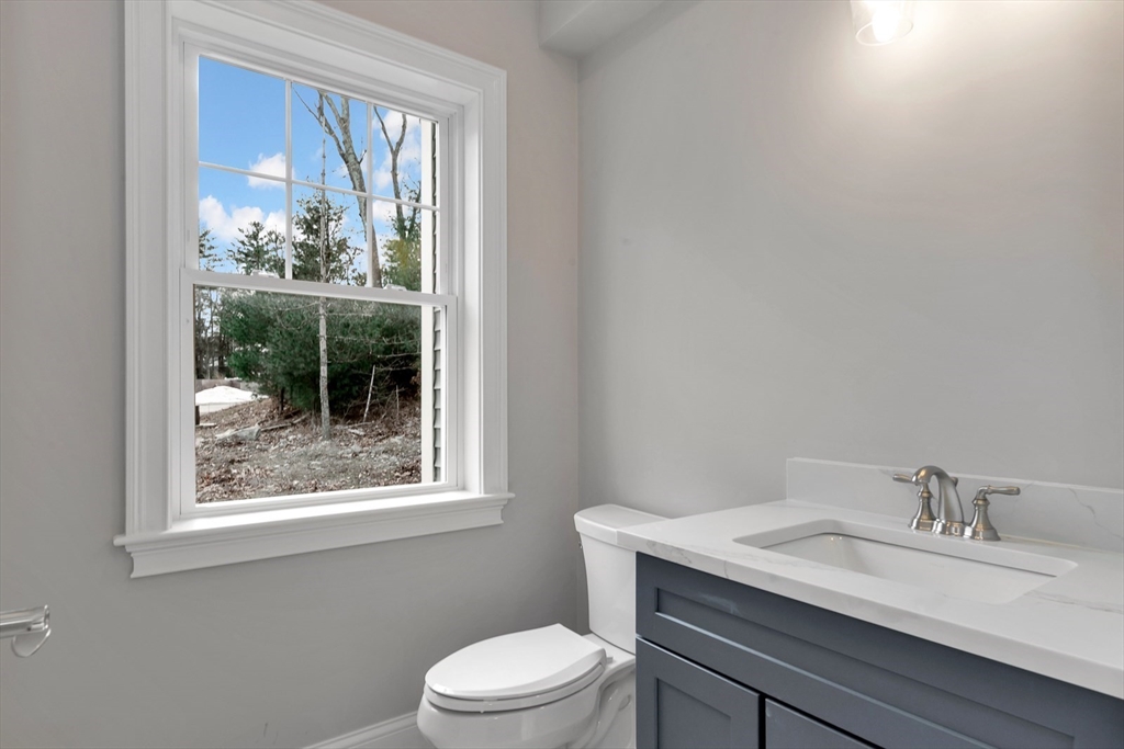 4 Weber Farm Road, Unit 4 Wrentham, MA 02093 - Photo 3 of 17 a bathroom with a toilet a sink and a window