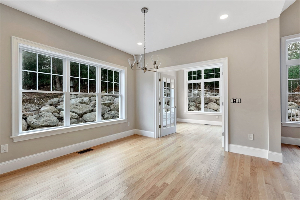 4 Weber Farm Road, Unit 4 Wrentham, MA 02093 - Photo 7 of 17 an empty room with wooden floor and windows