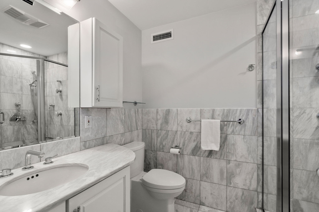 150 Country Club Road Newton, MA 02459 - Photo 13 of 33 a bathroom with a sink toilet and shower