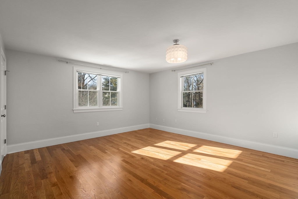 150 Country Club Road Newton, MA 02459 - Photo 19 of 33 a view of empty room with wooden floor and fan