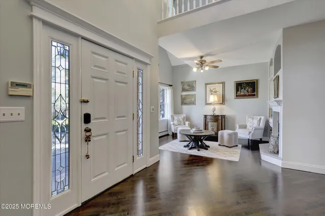 a large kitchen with stainless steel appliances kitchen island granite countertop a stove a sink a refrigerator and a dining table with wooden floor