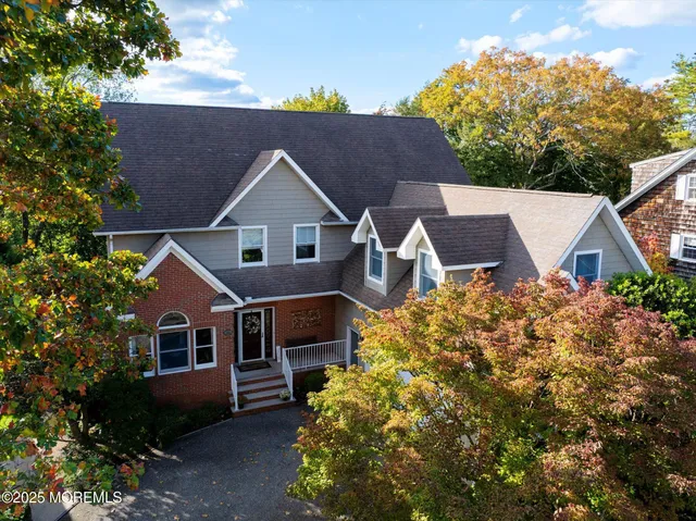 a view of a hallway with wooden floor and stairs