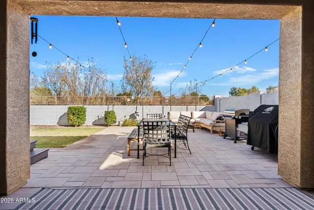 a view of a patio with dining table and chairs with wooden floor