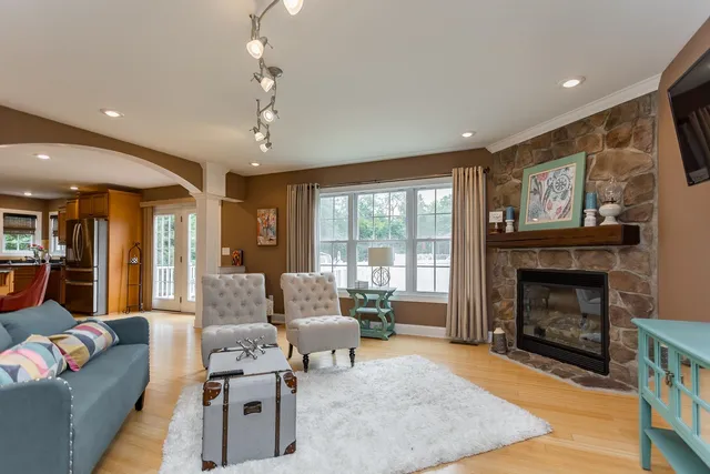 a kitchen with stainless steel appliances granite countertop a kitchen island hardwood floor sink stove and granite counter top