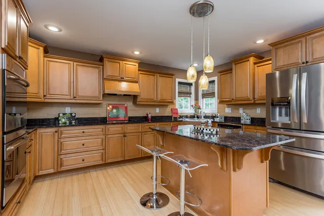 a bathroom with a granite countertop sink mirror and vanity