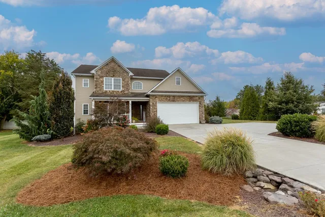 a front view of a house with garden