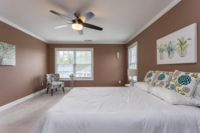 a view of a room with a wardrobe space and windows