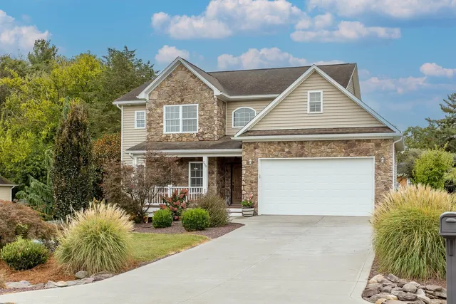 an aerial view of a house with garden space and street view