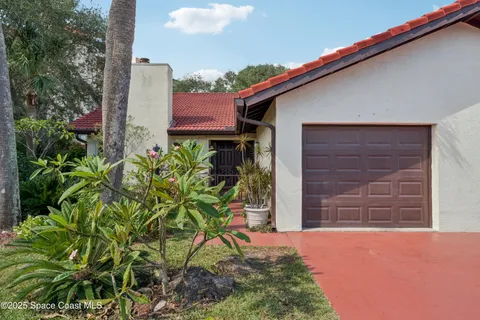 a backyard of a house with chairs