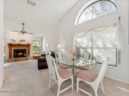 a dining room with furniture a fireplace and chandelier