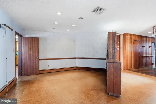 a kitchen with granite countertop a stove top oven cabinets and a window
