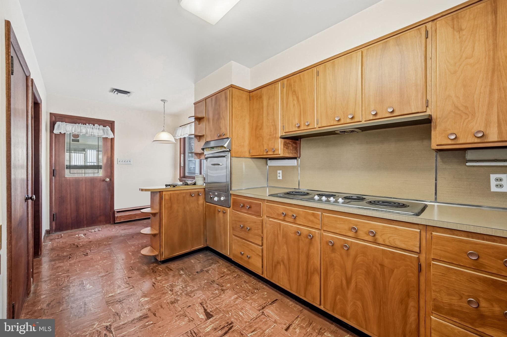 23 Lake Street Bridgeton, NJ 08302 - Photo 31 of 58 a kitchen with granite countertop a stove top oven cabinets and a window