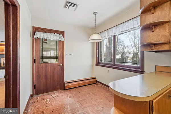 a bathroom with a granite countertop sink a mirror and shower
