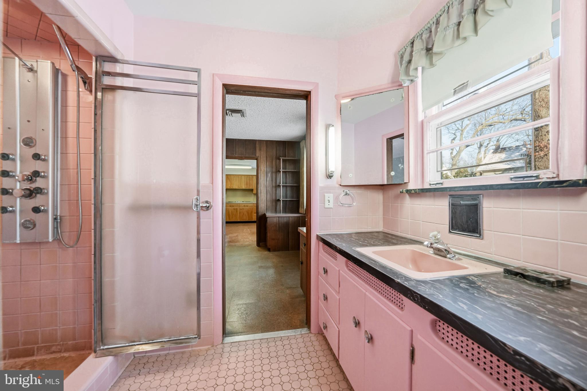 23 Lake Street Bridgeton, NJ 08302 - Photo 38 of 58 a bathroom with a granite countertop sink a mirror and shower