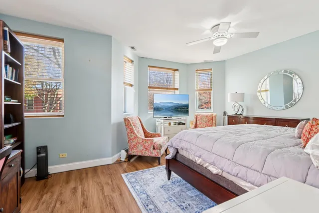 a bedroom with a bed a mirror and a window