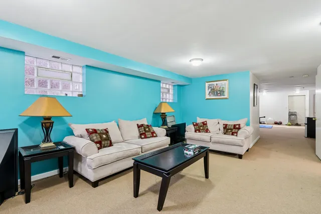 a living room with furniture and a lamp