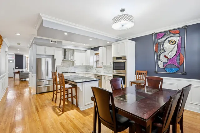 a dining room with furniture and wooden floor
