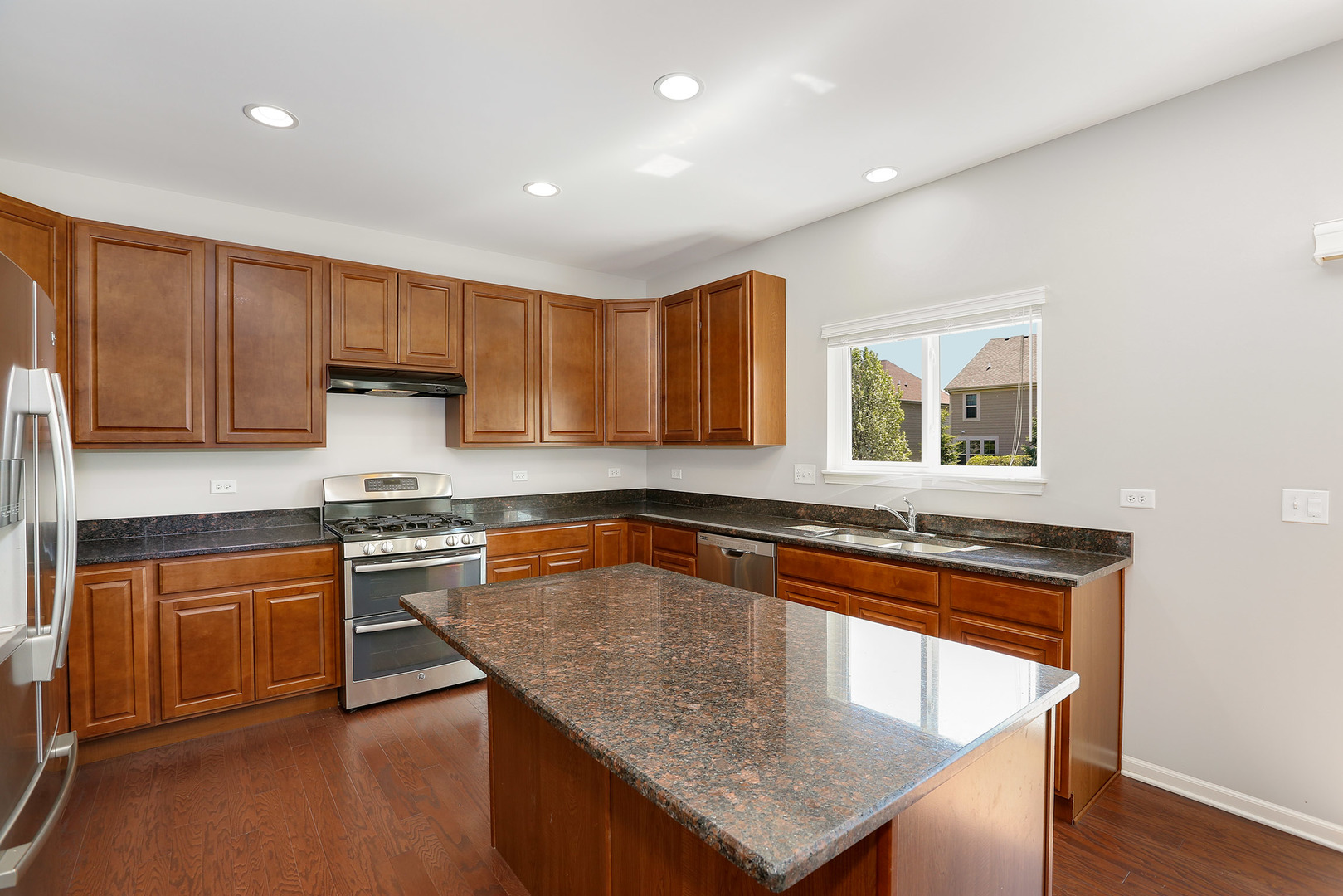 3531 English Prairie Road Elgin, IL 60124 - Photo 11 of 34 a kitchen with stainless steel appliances granite countertop microwave stove top oven and cabinets