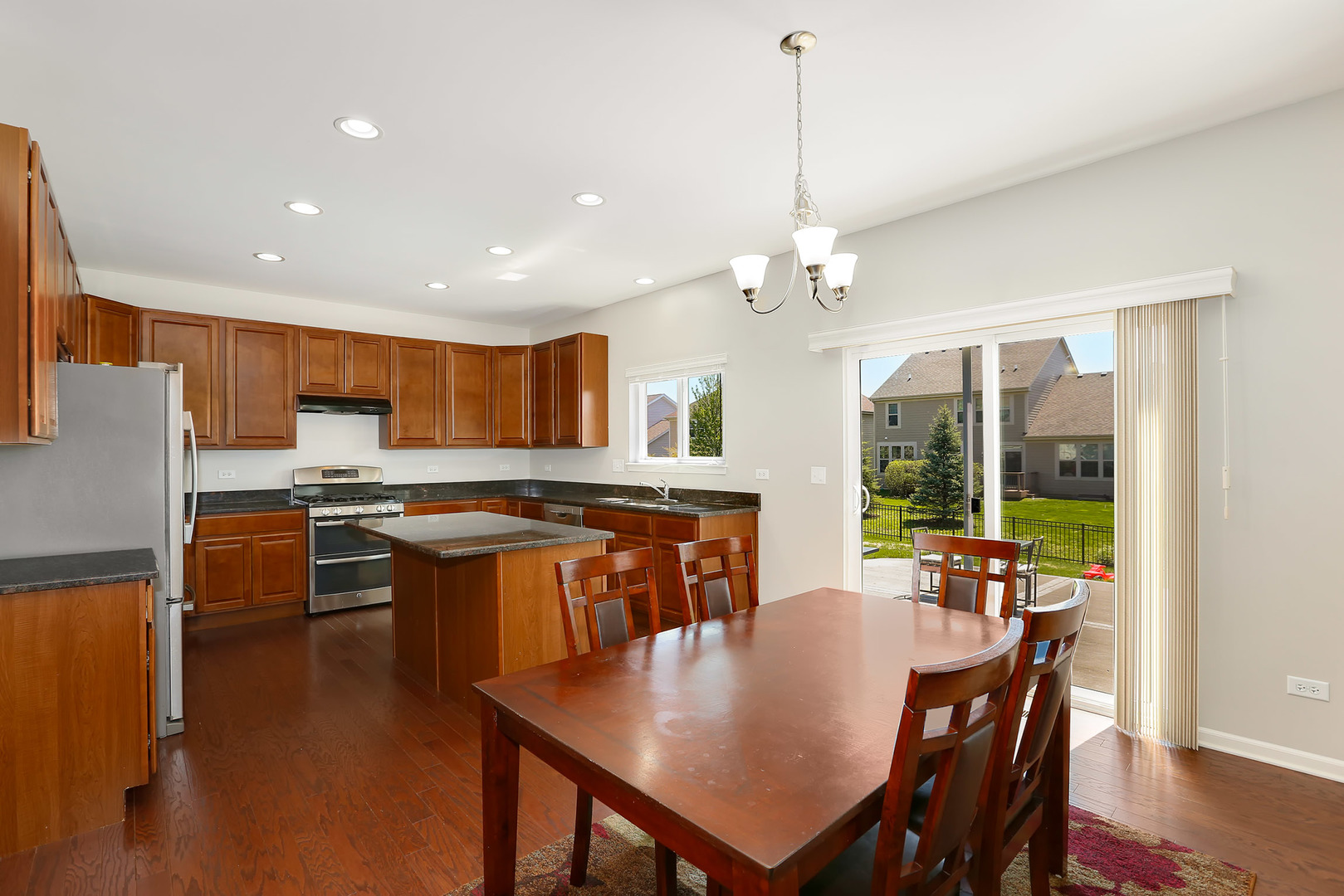 3531 English Prairie Road Elgin, IL 60124 - Photo 12 of 34 a open dining room with stainless steel appliances granite countertop a kitchen island a table and chairs