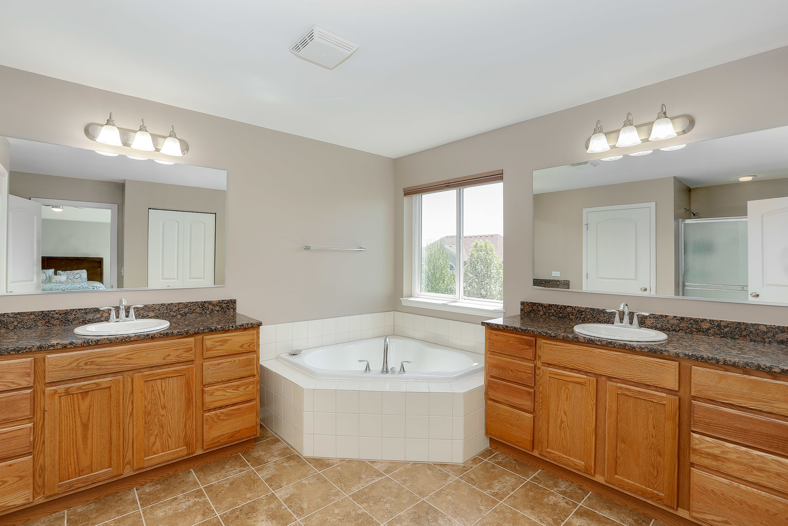 3531 English Prairie Road Elgin, IL 60124 - Photo 19 of 34 a bathroom with a granite countertop double vanity sink a mirror and a bathtub