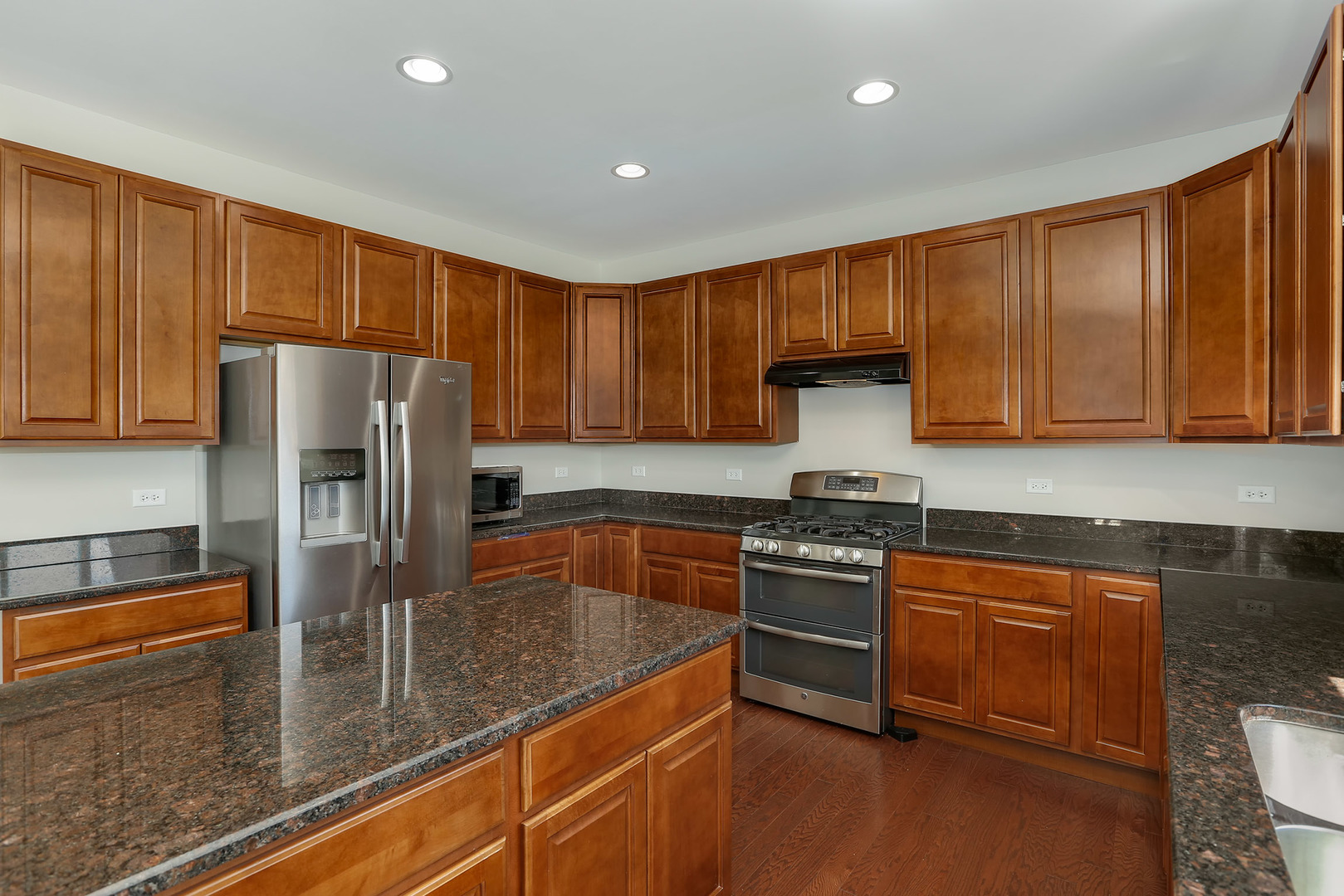 3531 English Prairie Road Elgin, IL 60124 - Photo 10 of 34 a kitchen with stainless steel appliances granite countertop a refrigerator a stove and a sink with wooden cabinets