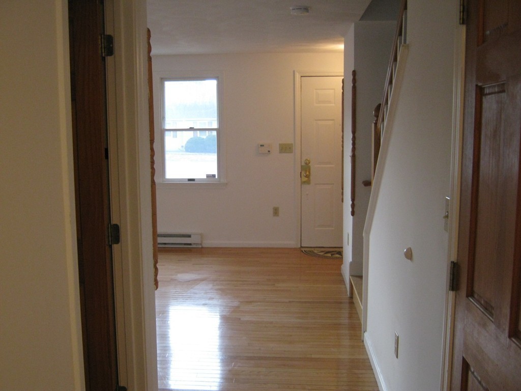 65 Victoria Heights Road, Unit 65 Boston, MA 02136 - Photo 4 of 16 a view of an empty room with wooden floor and a window
