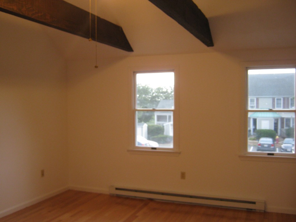 65 Victoria Heights Road, Unit 65 Boston, MA 02136 - Photo 7 of 16 a view of a small space with wooden floor and a window