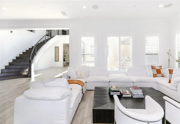 a kitchen with stainless steel appliances granite countertop a sink a stove and a wooden floors