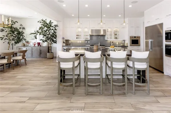 a kitchen with a microwave a stove and white cabinets