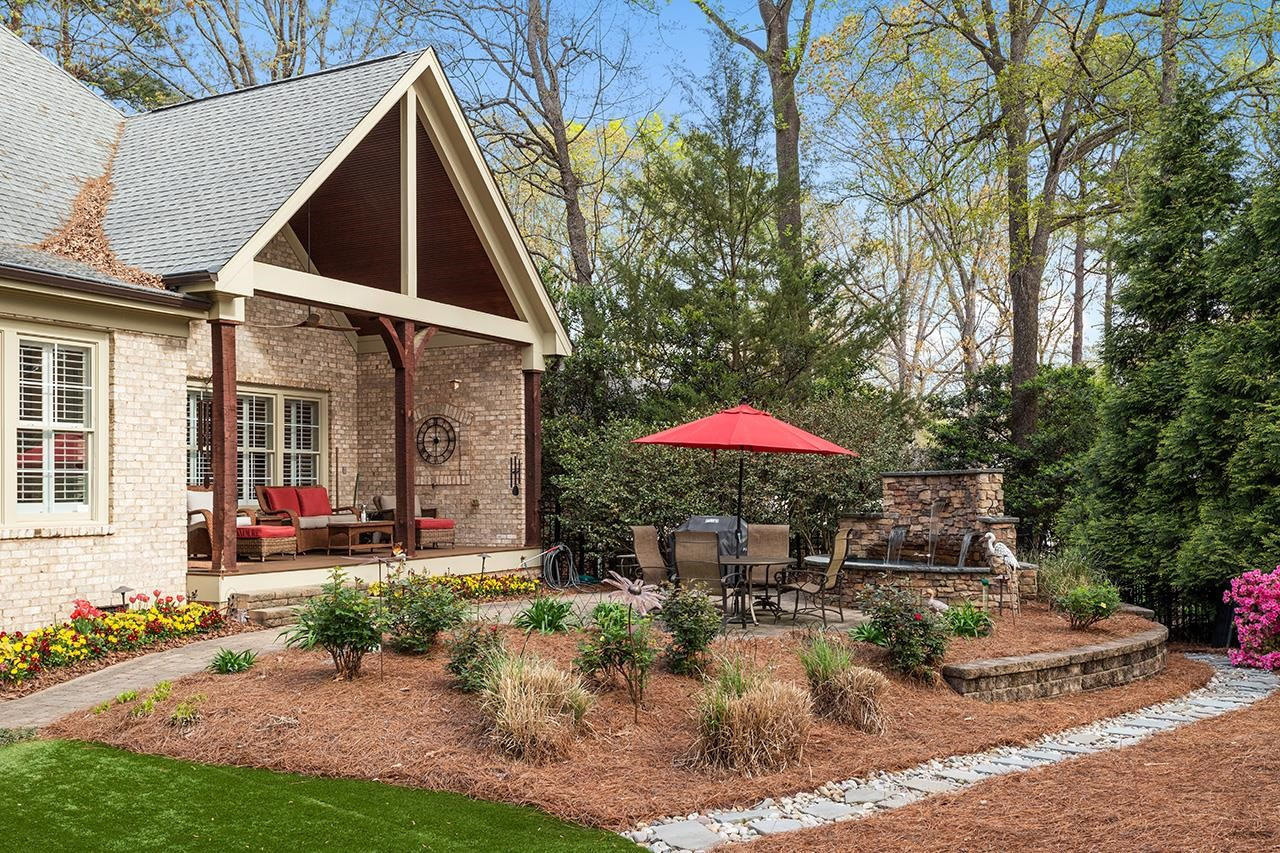 1116 Hunting Ridge Road Raleigh, NC 27615 - Photo 15 of 91 a view of a house with backyard sitting area and garden