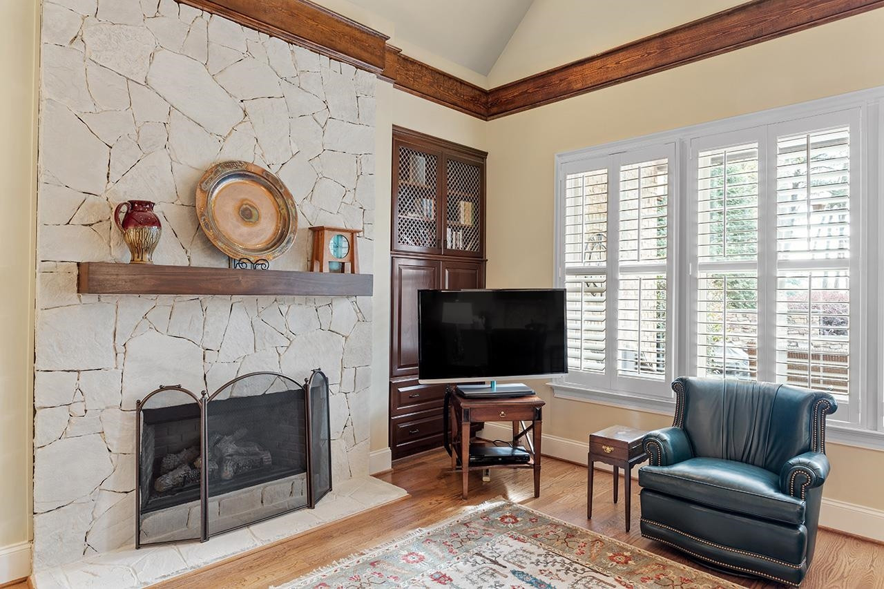 1116 Hunting Ridge Road Raleigh, NC 27615 - Photo 27 of 91 a living room with furniture a flat screen tv and a fireplace