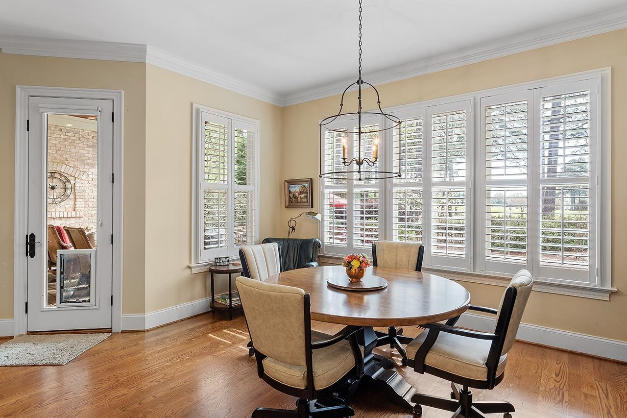 1116 Hunting Ridge Road Raleigh, NC 27615 - Photo 31 of 91 a view of a dining room with furniture window and wooden floor