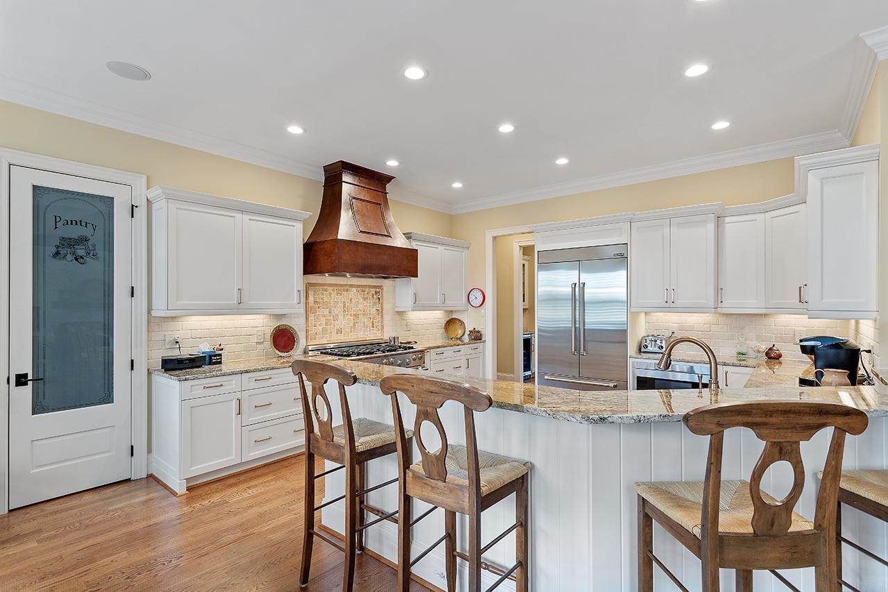 1116 Hunting Ridge Road Raleigh, NC 27615 - Photo 33 of 91 a kitchen with stainless steel appliances granite countertop a sink and a refrigerator