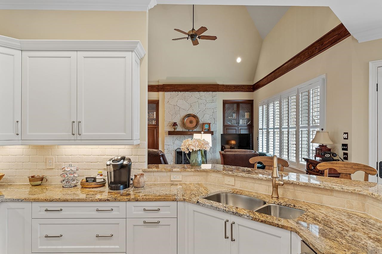 1116 Hunting Ridge Road Raleigh, NC 27615 - Photo 36 of 91 a kitchen with stainless steel appliances granite countertop a sink dishwasher a stove and white cabinets with wooden floor