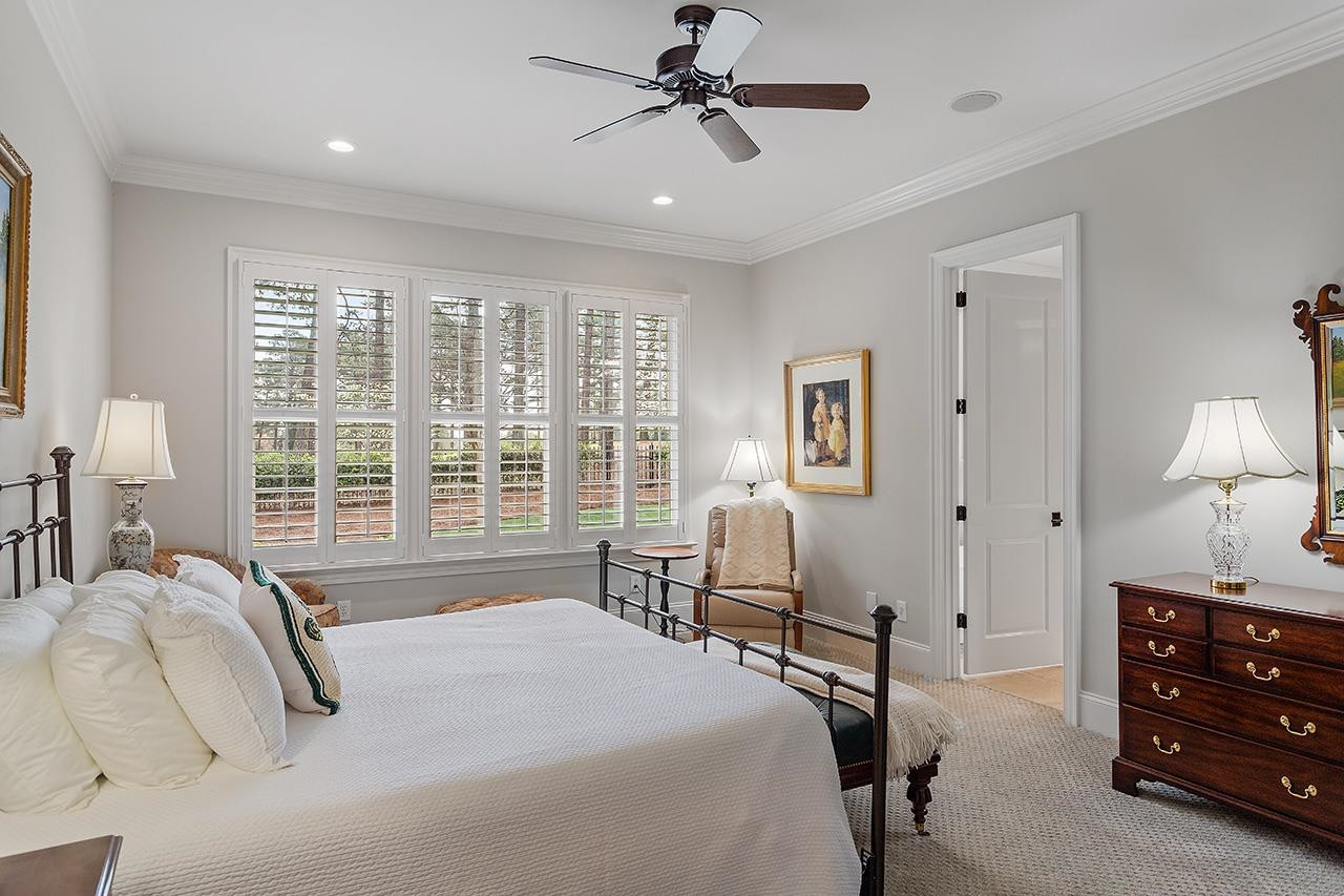 1116 Hunting Ridge Road Raleigh, NC 27615 - Photo 45 of 91 a bedroom with a bed a chandelier and a window