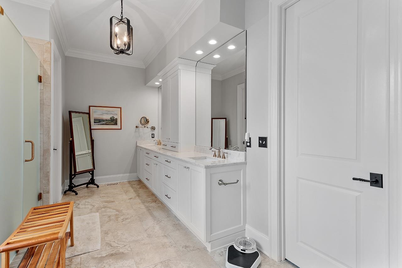 1116 Hunting Ridge Road Raleigh, NC 27615 - Photo 48 of 91 a bathroom with a double vanity sink a mirror and shower