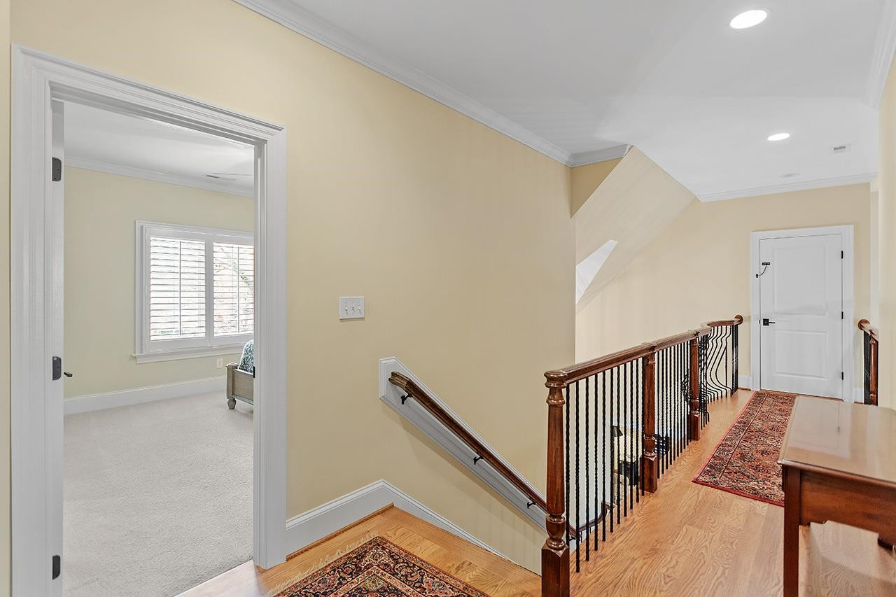 1116 Hunting Ridge Road Raleigh, NC 27615 - Photo 53 of 91 a view of a hallway with windows and stairs