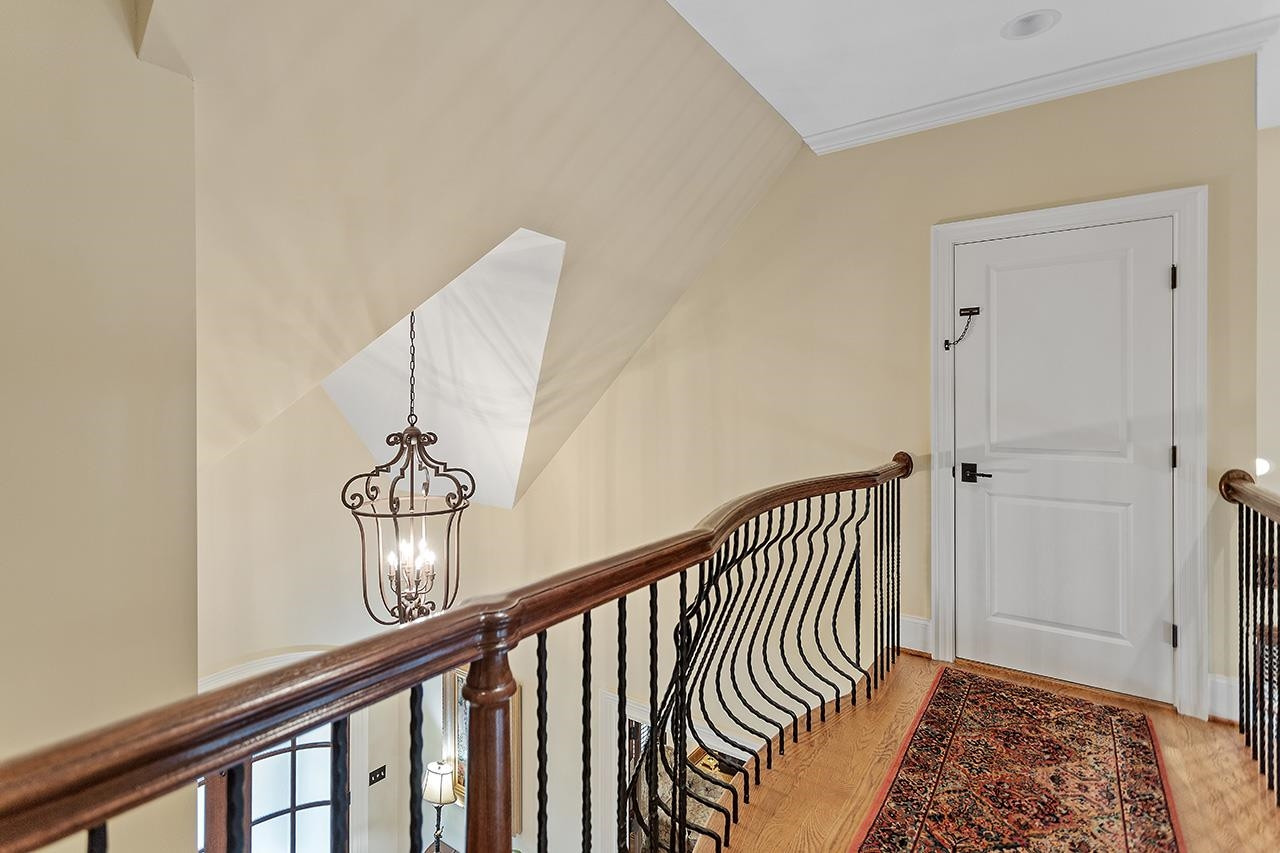 1116 Hunting Ridge Road Raleigh, NC 27615 - Photo 54 of 91 a view of staircase with railing and a rug