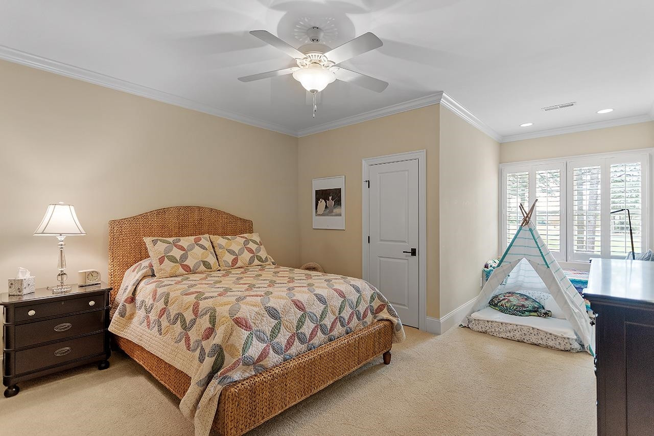 1116 Hunting Ridge Road Raleigh, NC 27615 - Photo 56 of 91 a bedroom with a bed and a chandelier