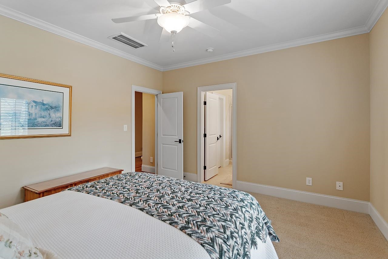 1116 Hunting Ridge Road Raleigh, NC 27615 - Photo 60 of 91 a bedroom with a large bed and a chandelier