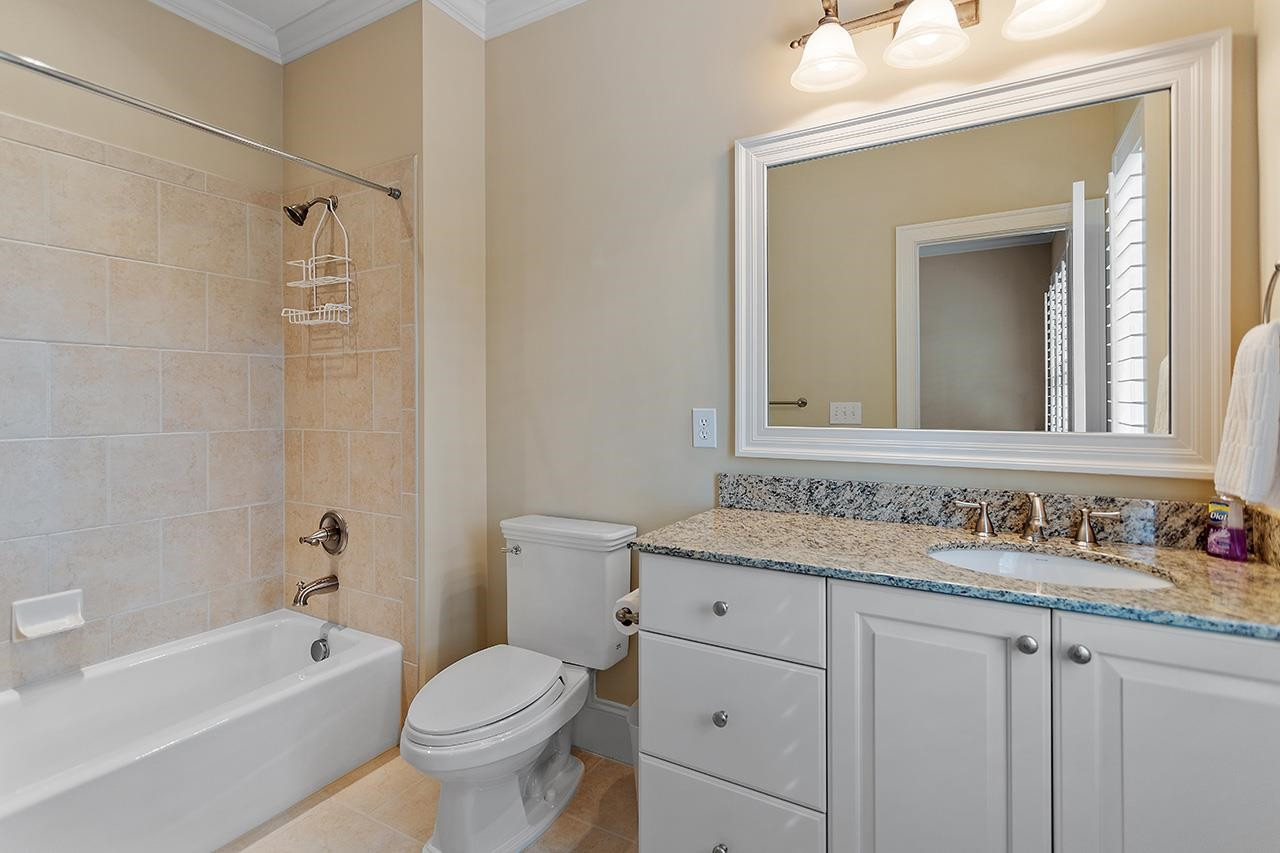 1116 Hunting Ridge Road Raleigh, NC 27615 - Photo 63 of 91 a bathroom with a granite countertop toilet a sink and a bathtub