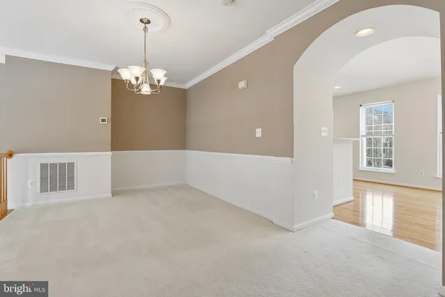 a view of a livingroom with a chandelier a kitchen and chandelier