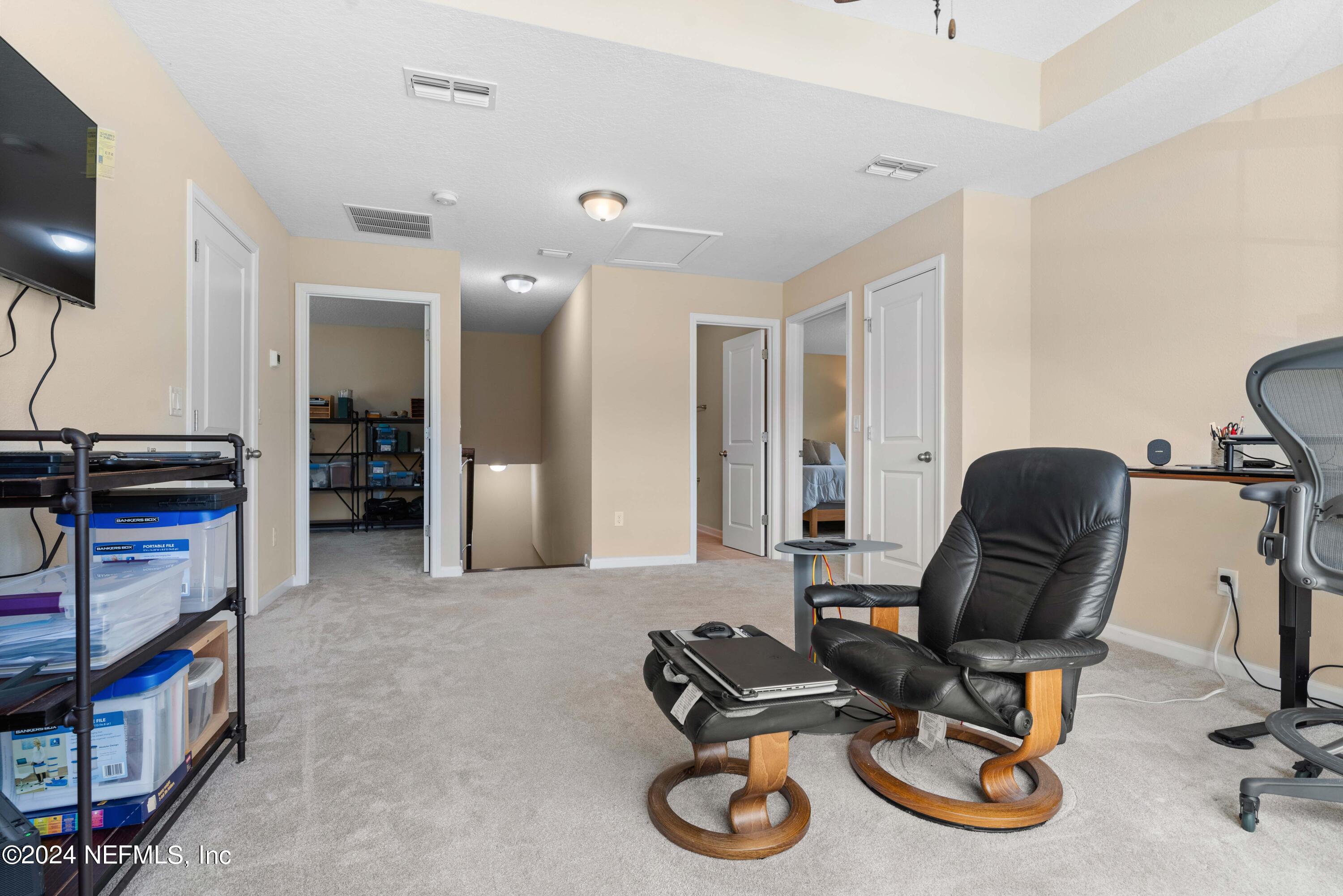 245 Floco Avenue Yulee, FL 32097 - Photo 19 of 38 a view of a workspace with furniture and a window