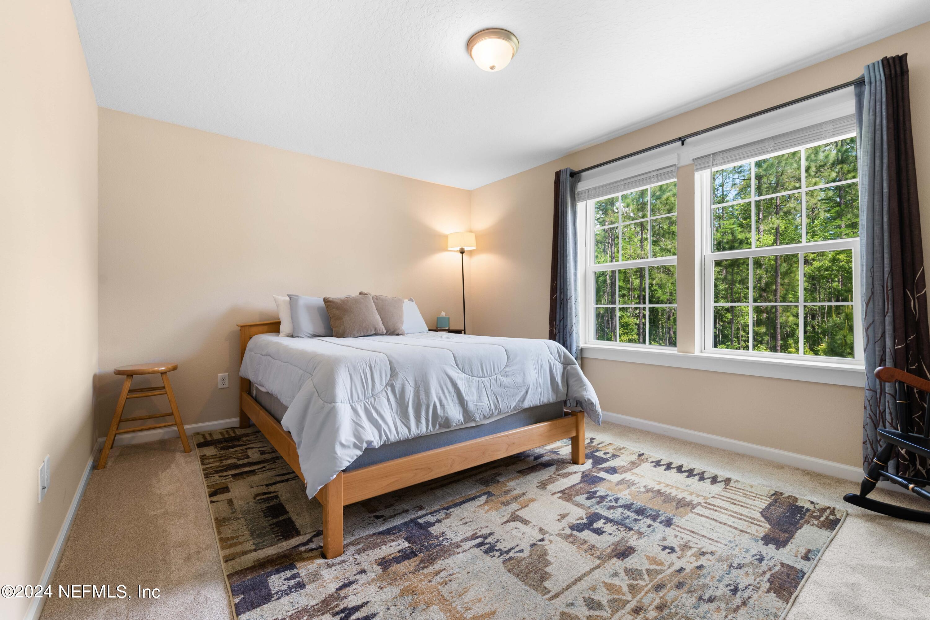 245 Floco Avenue Yulee, FL 32097 - Photo 20 of 38 a bedroom with a bed and a window