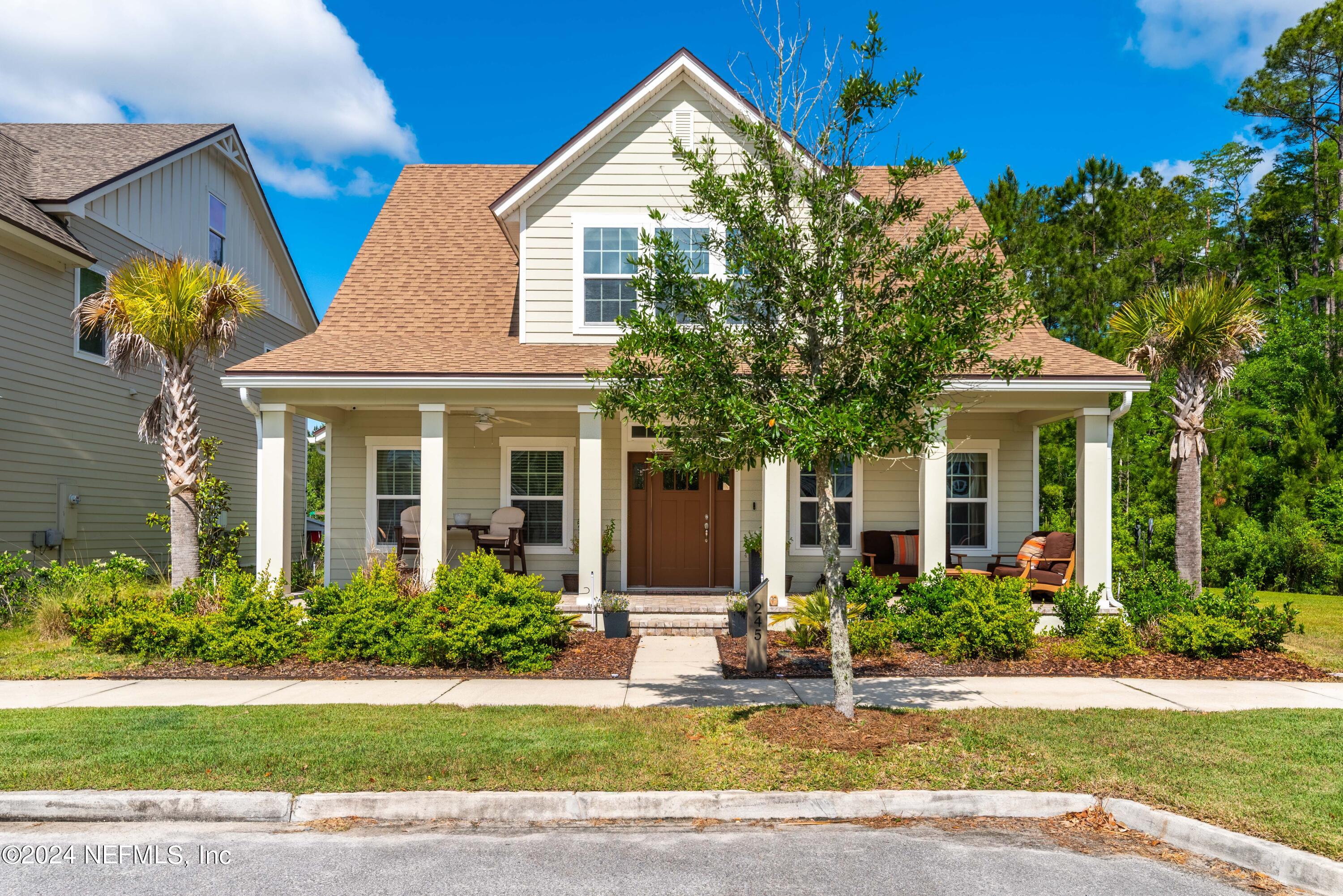 245 Floco Avenue Yulee, FL 32097 - Photo 2 of 38 a front view of a house with garden
