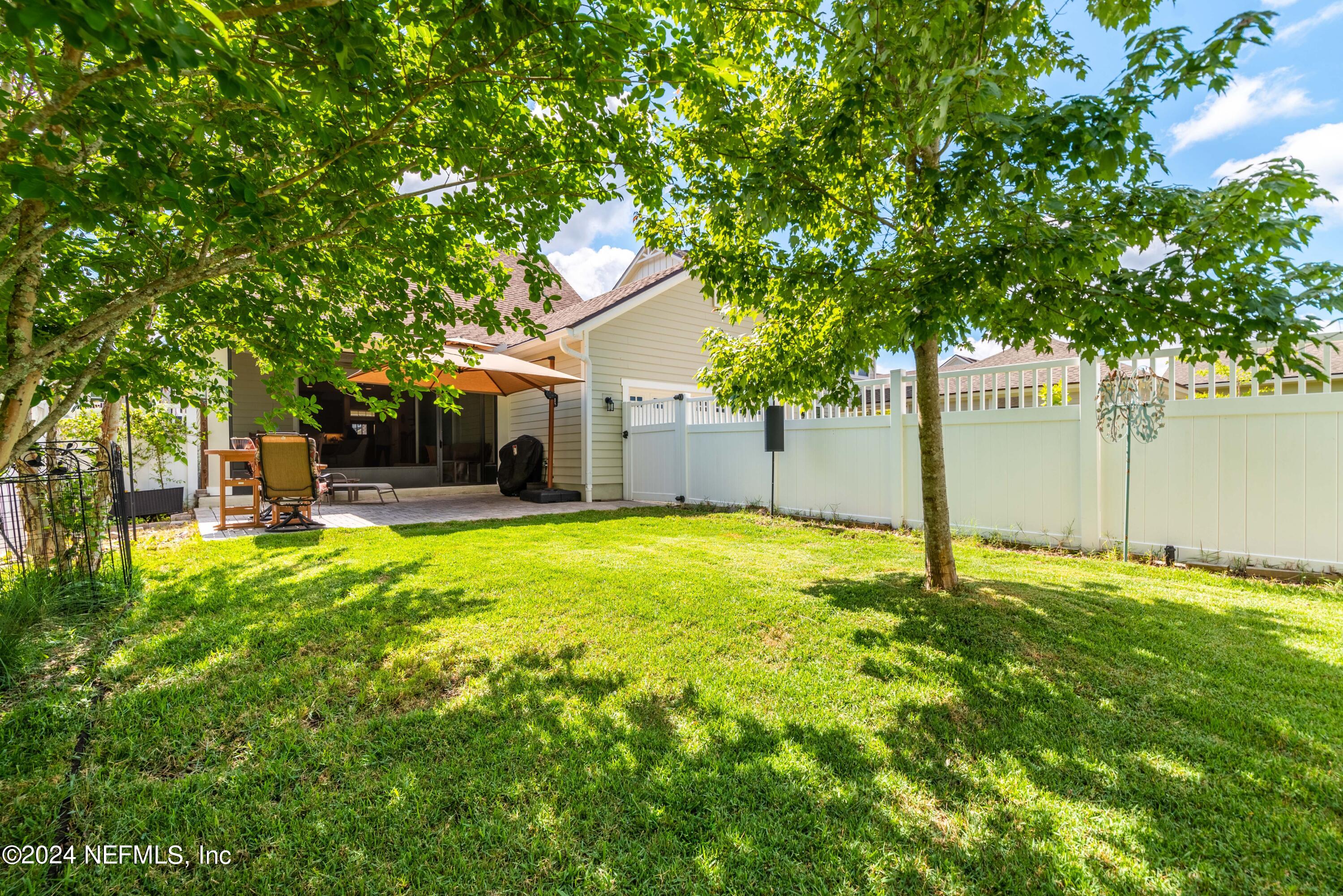 245 Floco Avenue Yulee, FL 32097 - Photo 27 of 38 a backyard of a house with table and chairs